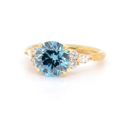 Round Blue Diamond Engagement Ring with Scattered Round Diamond Side Stones Custom Engagement Rings