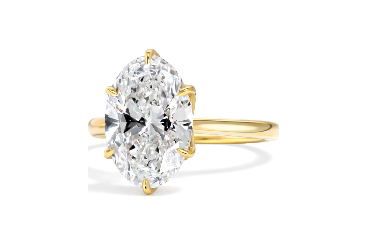 Peter Norman Oval Cut Diamond Ring with Floral Prongs and Engraved Bridge